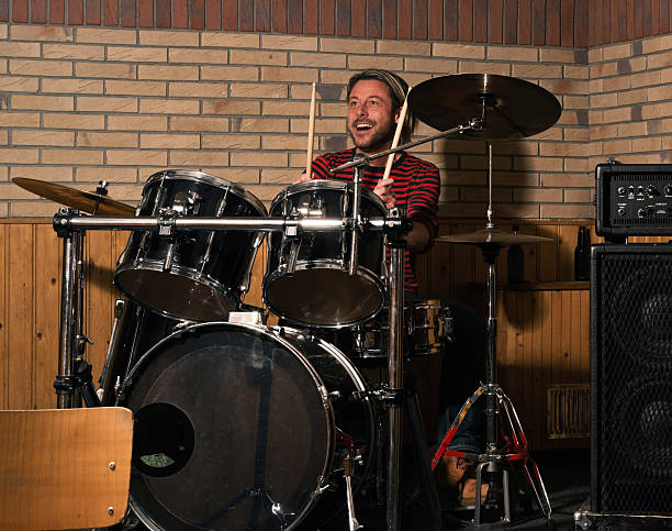istock Energetic rock drummer in action. Long blonde hair. Jam session. 483837791