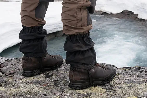 Hking-Shoes facing a waterfall, surrounded by ice