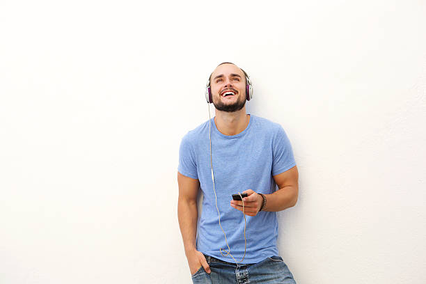 istock Smiling young man with mobile phone and headphones 483841124
