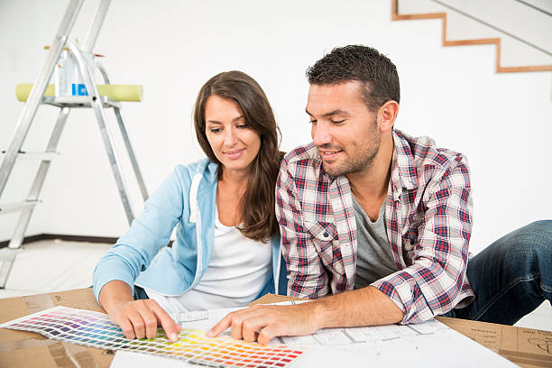 istock couple in new home choosing wall paint colors 483842780