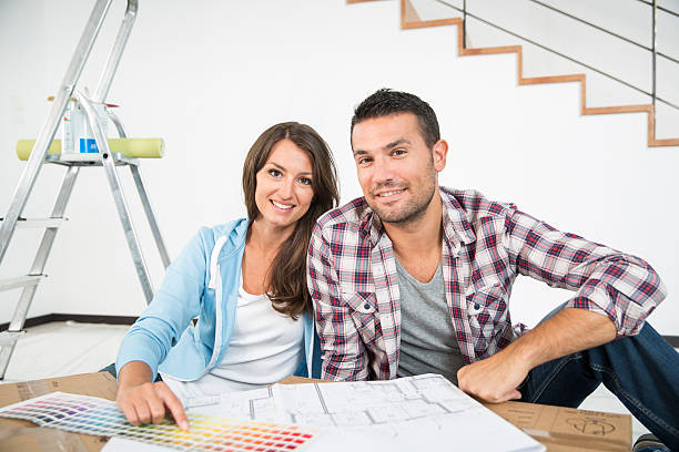 istock couple in new home choosing wall paint colors 483842782