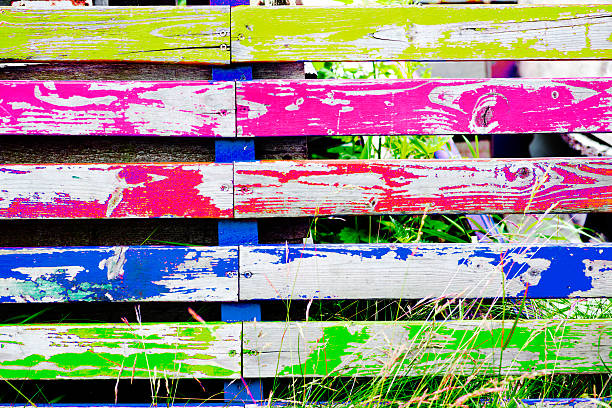 istock multicolored wooden fence with grass 483843120