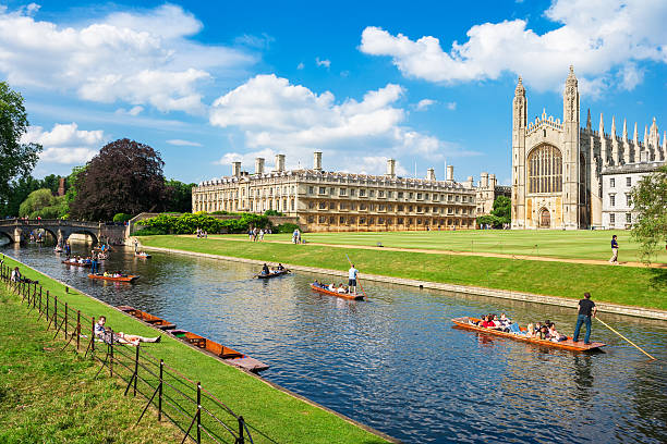 Tourists near Kings College in Cambridge University, England Cambridge, Cambridgeshire, England - June 24, 2006: Tourists on punt trip (sightseeing with boat) along River Cam near Kings College in the city of Cambridge, England cambridge england stock pictures, royalty-free photos & images