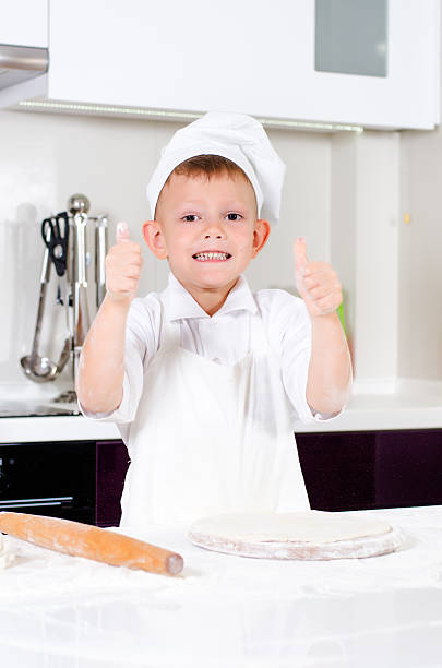 istock Happy little chef making homemade pizza 483844184