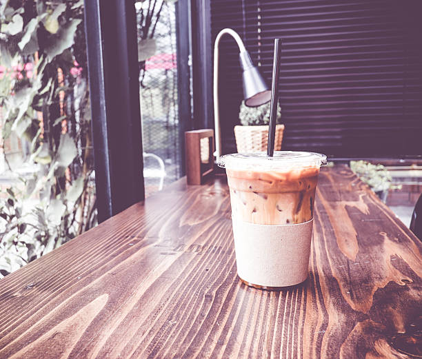 istock Vintage filter :Ice coffee on wood table in coffee 483851692