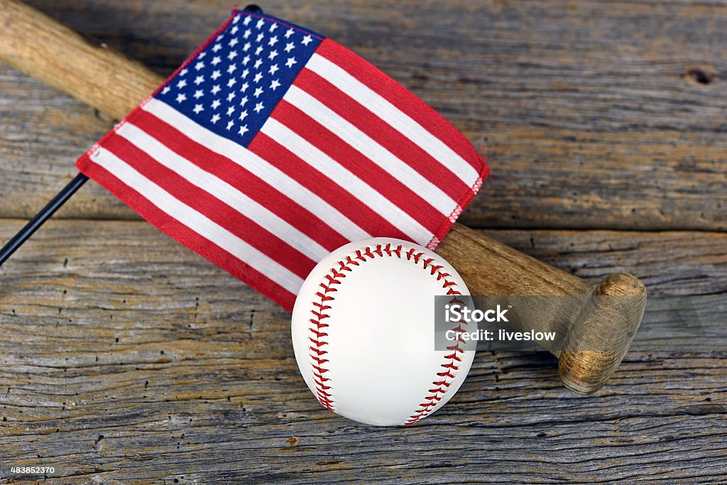 American flag on baseball bat American flag on a wooden baseball bat with baseball on rustic barn wood. 2015 Stock Photo