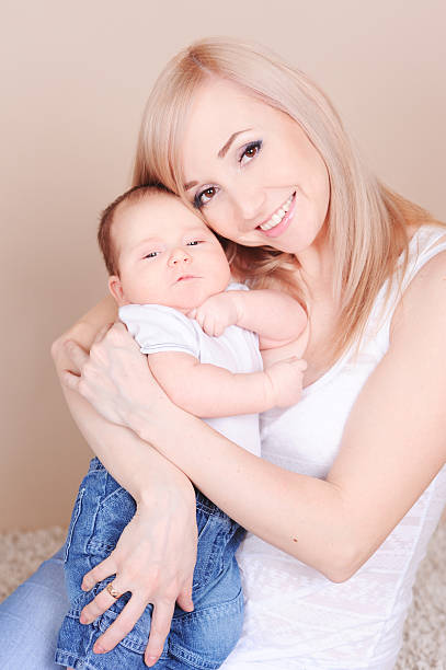istock Smiling woman holding baby boy 483855639