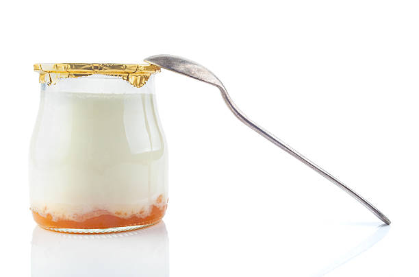 istock Greek yogurt with in a glass jars with spoon 483856447