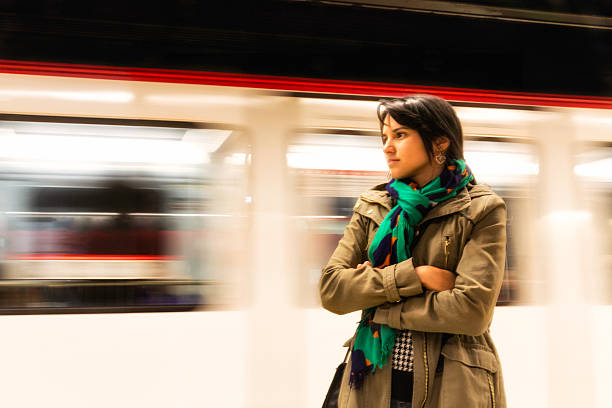 istock Serene young woman waiting before a moving subway train 483856977