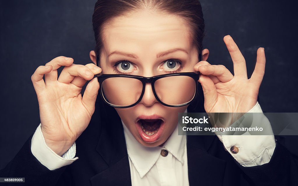 Surprised funny teacher in glasses shouts Surprised funny teacher in glasses shouts at the school board Adult Stock Photo