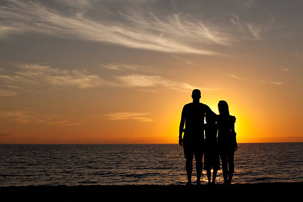 istock Young Family on the Beach at Sunset 483859121