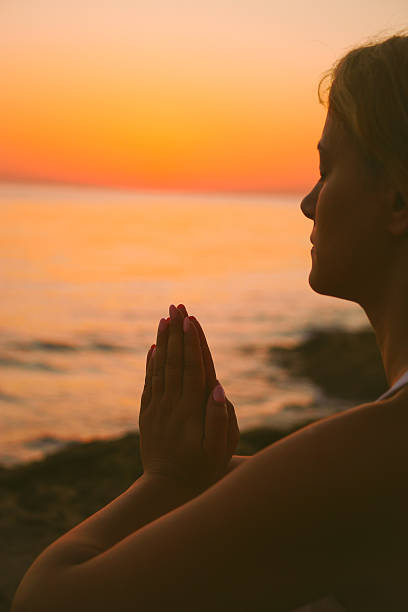 istock Girl meditating on beach 483860030