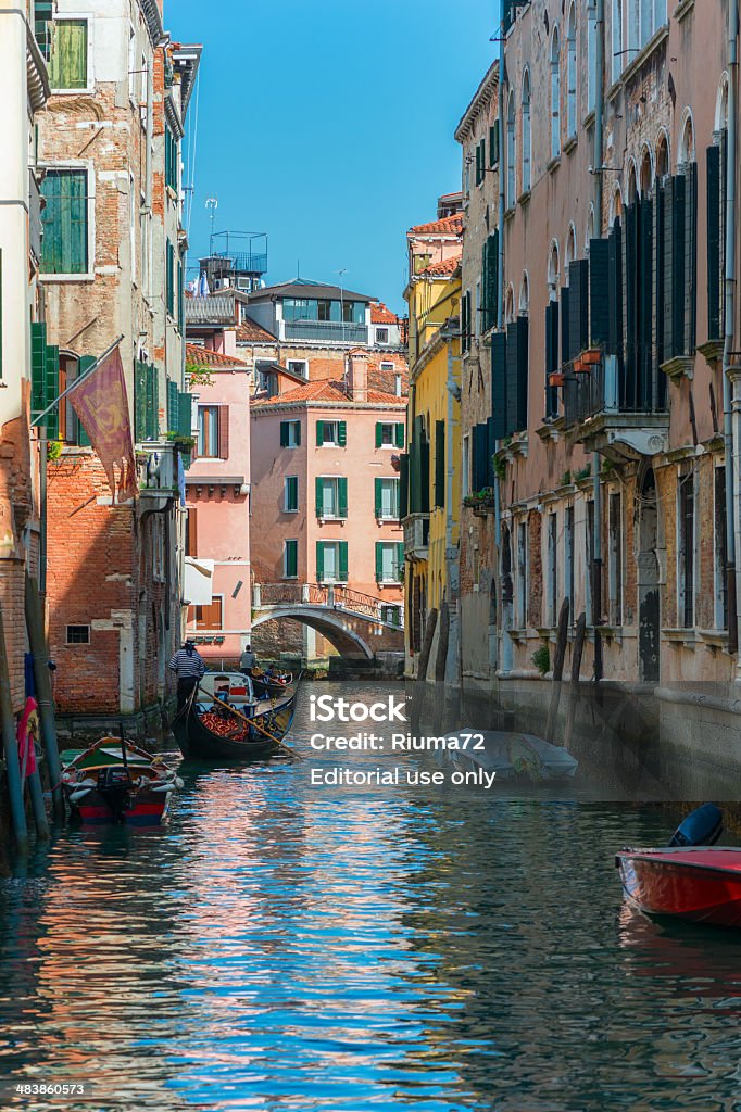 People go around over the gondola in Venice, Italy Venice, Italy - March 29, 2014. People go around over the gondola in Venice, Italy on March 29, 2014. Venice is one of most popular attractions in Italy and it is also a Unesco heritage site. Architecture Stock Photo