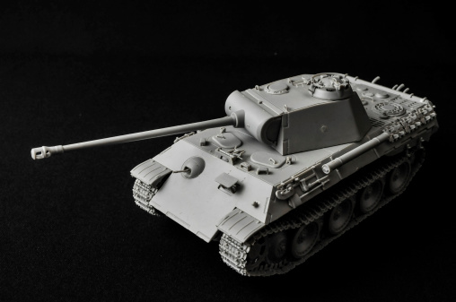 Modern War Concept Model Tank in the Middle of an Asphalt RoadThe Model Tank King Tiger 2 of WW2 on a White Background