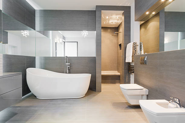 Freestanding bath in modern bathroom Designed freestanding bath in gray modern bathroom domestic bathroom stock pictures, royalty-free photos & images
