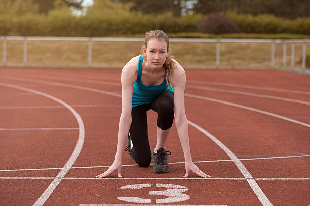 istock Young woman sprinter in the starter position 483862170