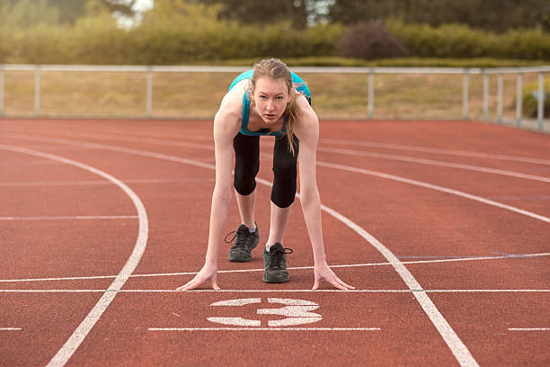 istock Young woman sprinter in the starter position 483862194