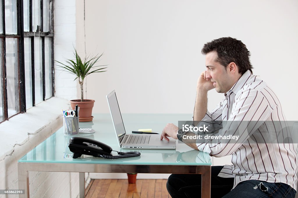 Home Office. Young man working at desk. Horizontal, space for copy. Adult Stock Photo