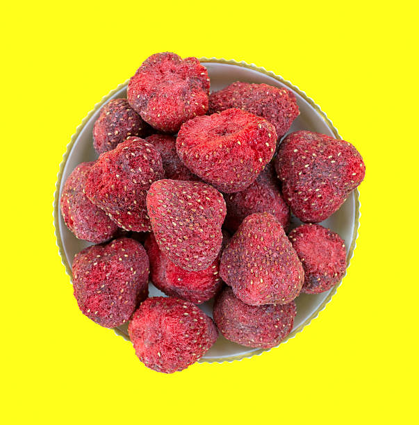istock Dried strawberries in bowl on yellow 483862489