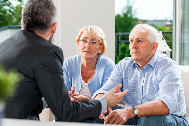 istock Senior couple talking with financial advisor 483862605
