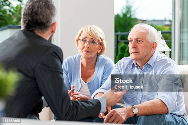 Senior Couple Talking With Financial Advisor Stock Photo - Download Image Now - Lawyer, Worried, Advice