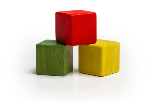 toy wooden blocks stack, pyramid of blank multicolor box cube over white background.