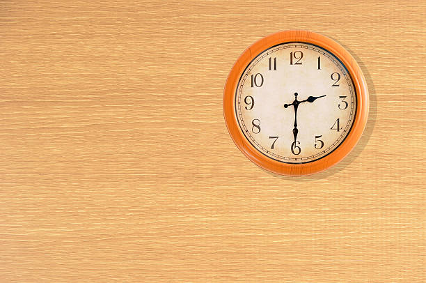 istock Clock showing 2:30 o'clock on a wooden wall 483868848