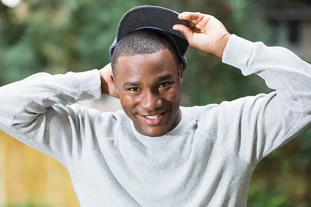 Photo of Happy young black man wearing gray cap