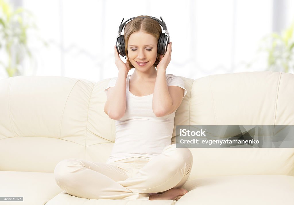 Belle fille dans les écouteurs appréciant la musique à la maison - Photo de Adulte libre de droits