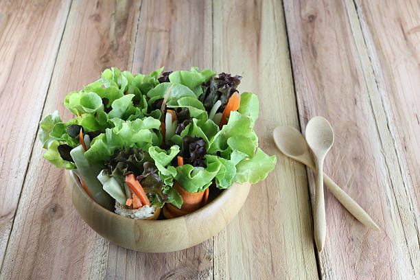 istock vegetable salad in wooden bowl. 483872054