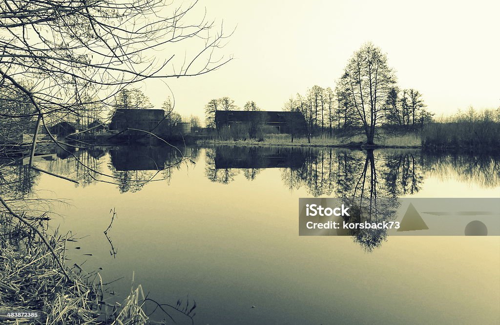 calm lake reflection of a building and trees in a lake in sweden by mikael lundgren Built Structure Stock Photo