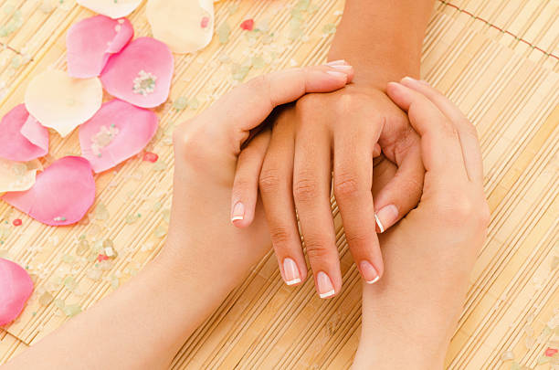 Hand massage Applying hand massage on bamboo surface. hand massage photos stock pictures, royalty-free photos & images