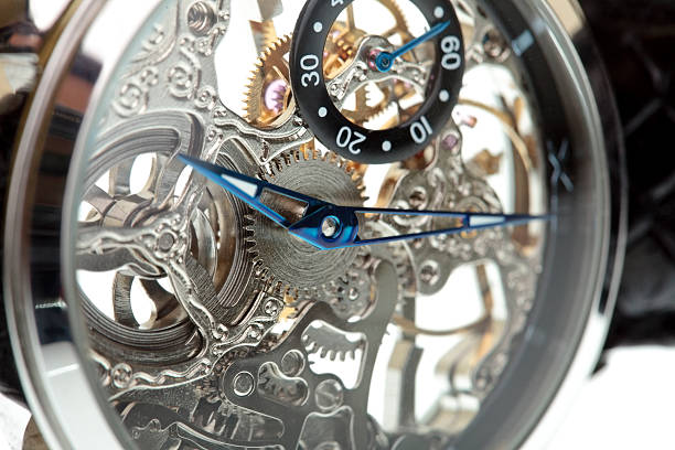 istock Closeup of a clock mechanism isolated on white 483873301
