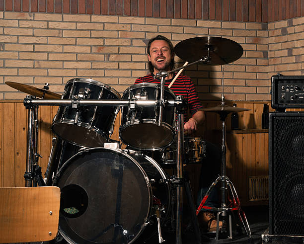 istock Energetic rock drummer in action. Long blonde hair. Jam session. 483873441