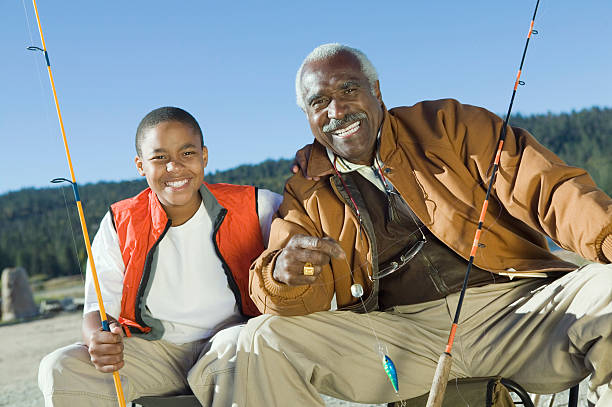 sorrir avô e neto de pesca - fishing active seniors family senior adult imagens e fotografias de stock