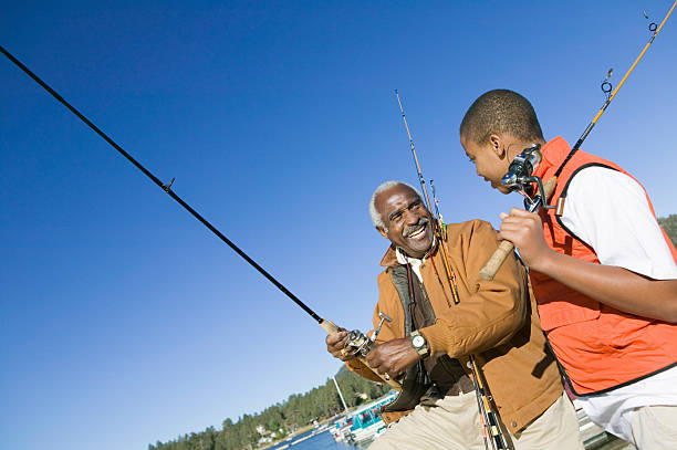 avô e neto de pesca - fishing active seniors family senior adult - fotografias e filmes do acervo