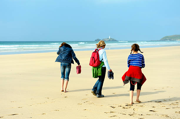 istock Family walking on the beach 483873963