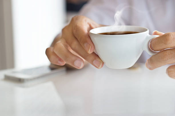 businessman and a cup of coffee in hand, blank text
