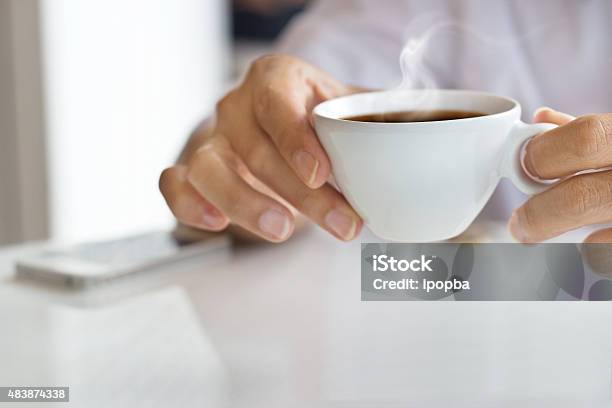 Businessman And A Cup Of Coffee In Hand Blank Text Stock Photo - Download Image Now