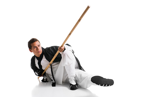 Stock photo of a Kung Fu Master in traditional dress isolated on white background.