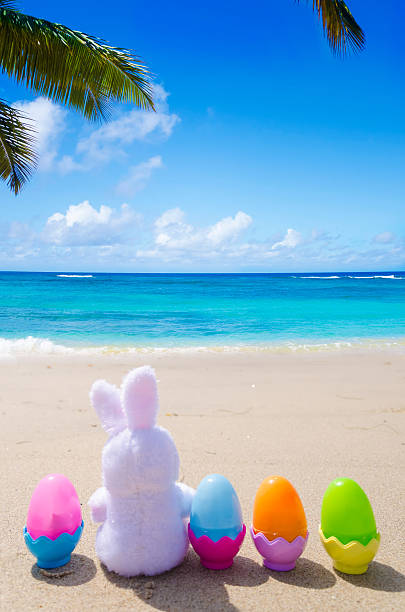 istock Easter bunny and color eggs on the beach 483874655