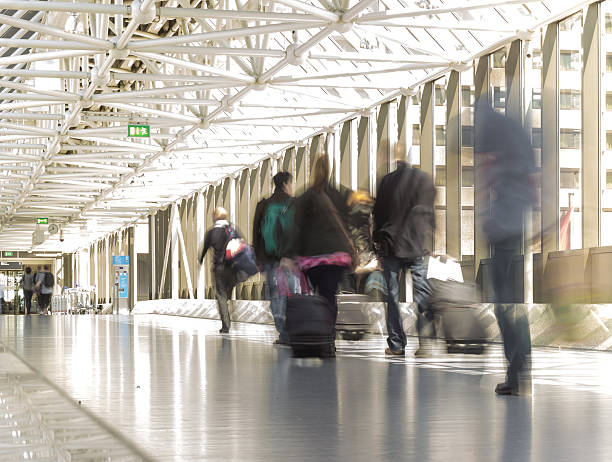istock blur  people and baggage walking on walkway with bokeh 483874664