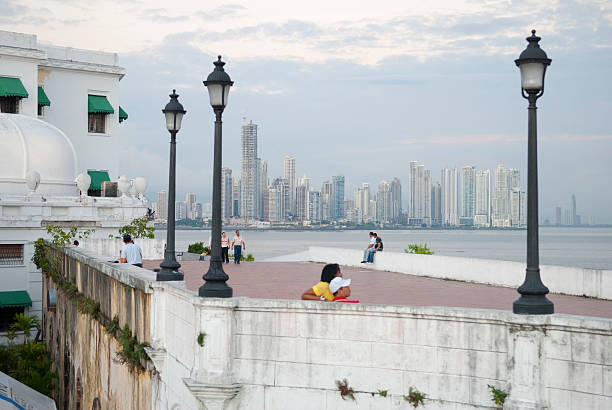 Panama City, Panama - December 22, 2008: View from the historic Casco Viejo district of the modern skyline in Panama City, Panama. People are walking and relaxing at the waterfront.