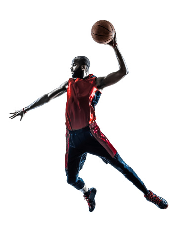 one african man basketball player jumping dunking in silhouette white background
