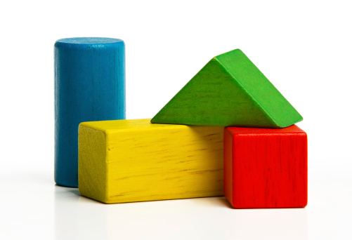 toy wooden blocks, multicolor building construction bricks over white background.