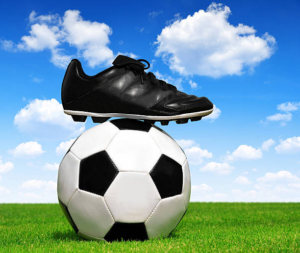 One soccer ball on grass with a blue sky, low angle view.