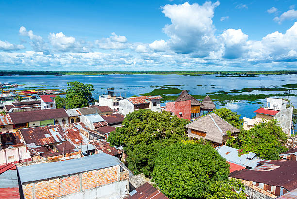Iquitos and River Cityscape view of Iquitos, Peru with the Itaya River in the background in the middle of the Amazon Rain Forest iquitos photos stock pictures, royalty-free photos & images