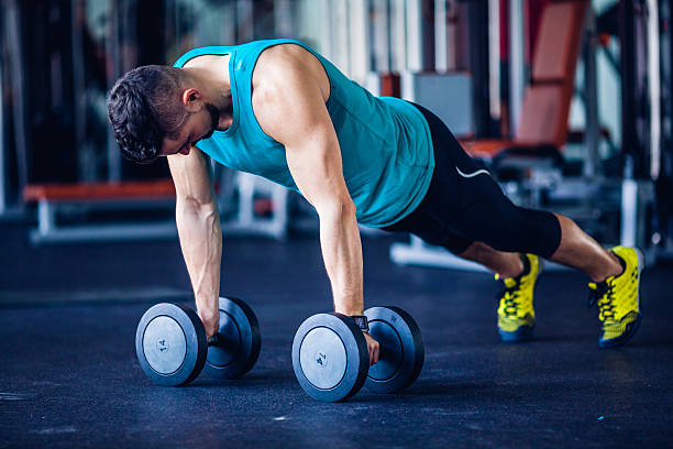 istock gym instructor at the gym doing pushups 483882384