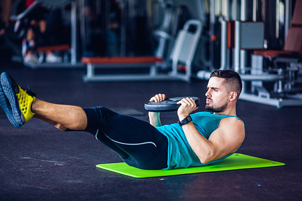 istock gym instructor at the gym doing abs exercises 483882388