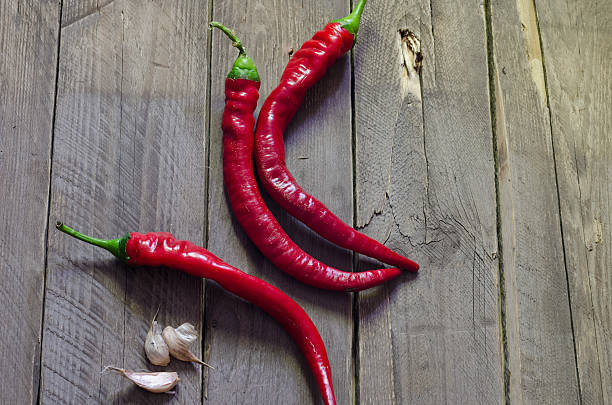 istock Red hot chili peppers on old wooden table 483882576